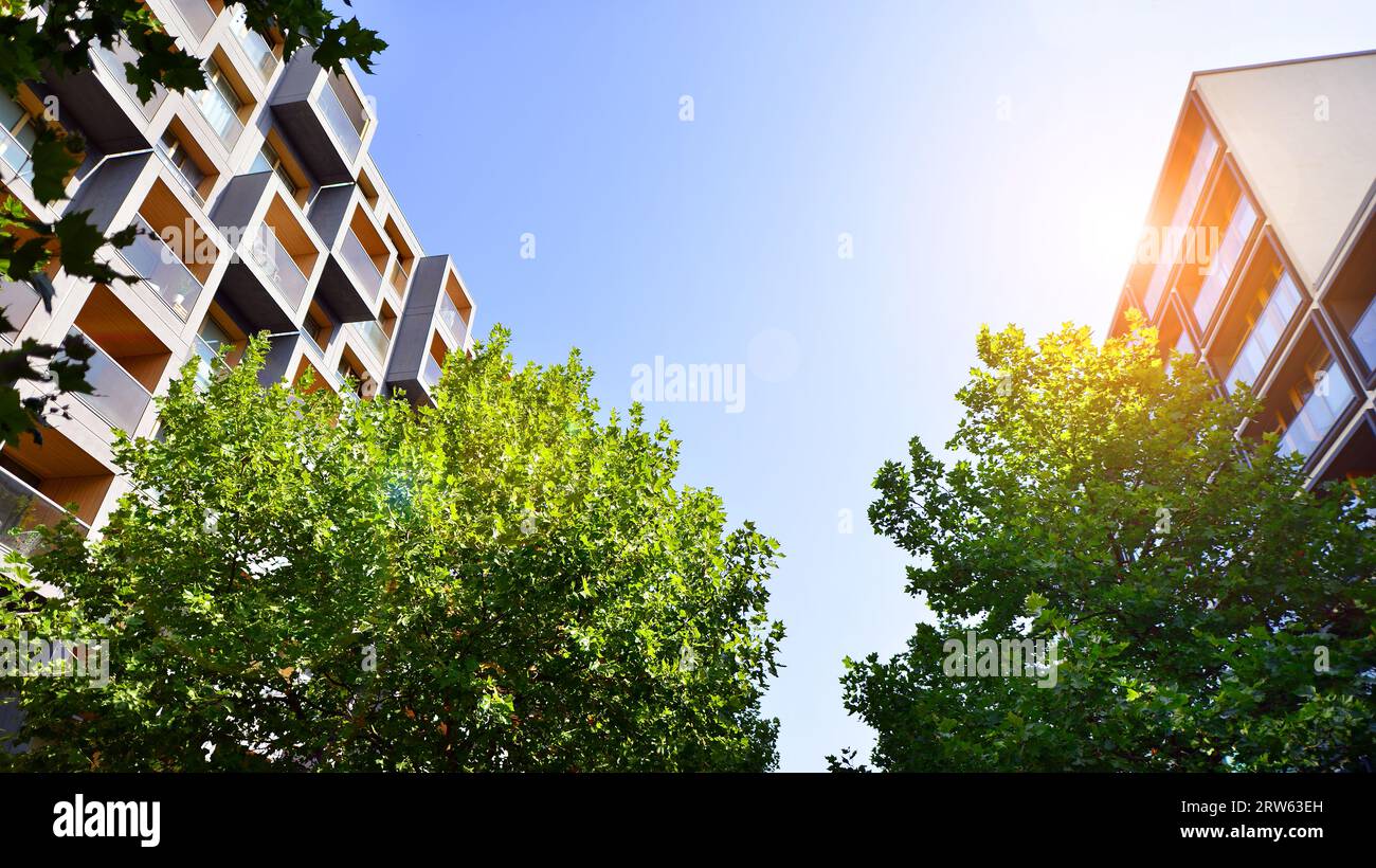 Modern apartment building and green trees Ecological housing