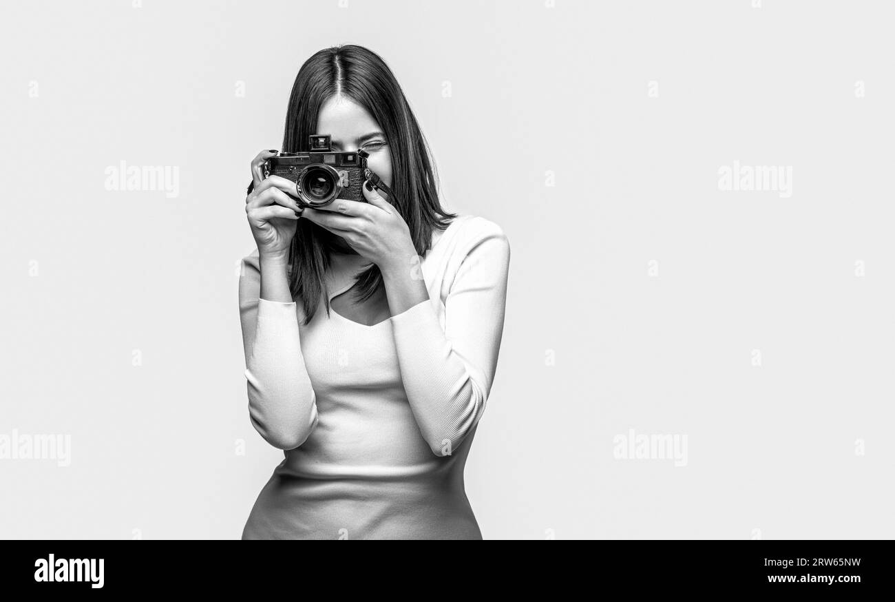 Girl with a cameras. Woman holding camera over gray background. Girl using a camera photo. Black and white Stock Photo
