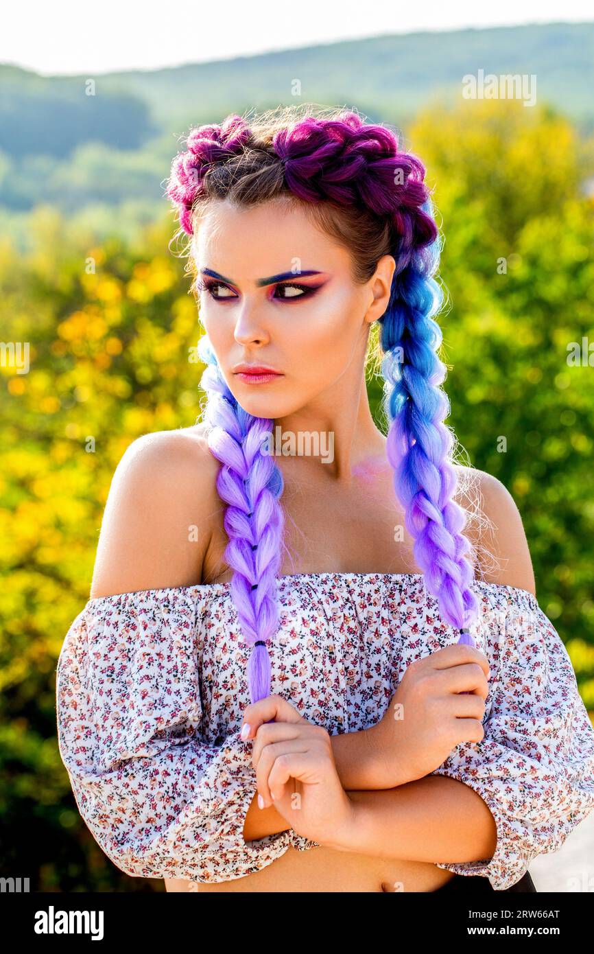 Girl braids. Bright makeup, rose-colored, braids, pigtails hairstyle. Girl  with colorful kanekalon braided in her hair. Pretty woman colorful violet  Stock Photo - Alamy