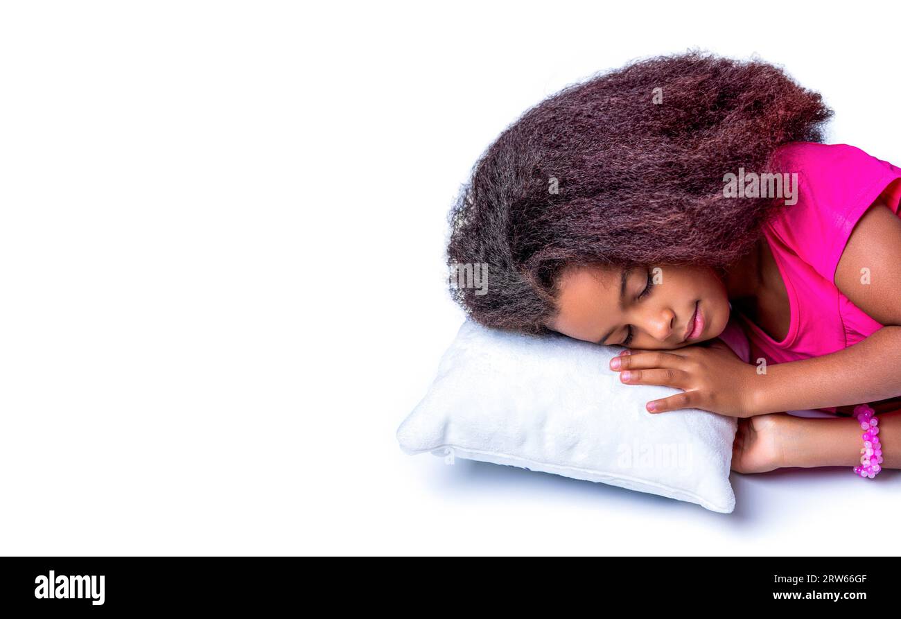 Children girl is sleeping a pillow on a white background. Multiracial