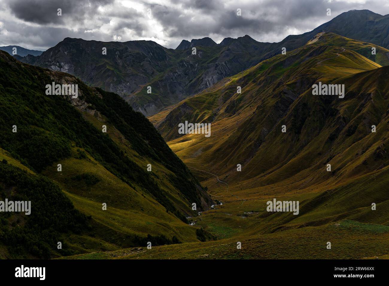 A stunning mountain range with rolling hills and lush green grass ...