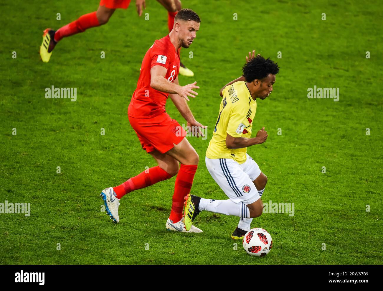 Moscow, Russia – July 3, 2018. Colombia national football team midfielder Juan Cuadrado against England midfielder Jordan Henderson during World Cup 2 Stock Photo