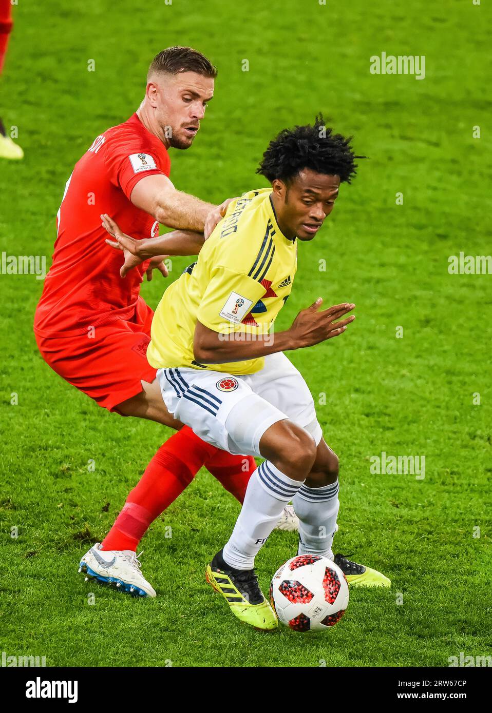 Moscow, Russia – July 3, 2018. Colombia national football team midfielder Juan Cuadrado against England midfielder Jordan Henderson during World Cup 2 Stock Photo