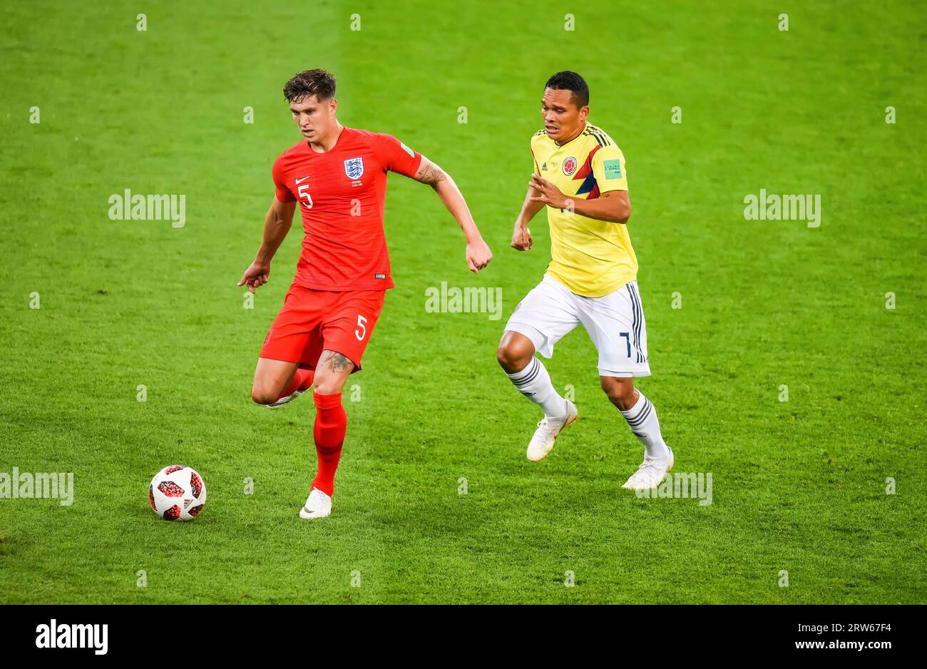 Moscow, Russia – July 3, 2018. England national football team centre-back John Stones against Colombia striker Carlos Bacca during World Cup 2018 Roun Stock Photo