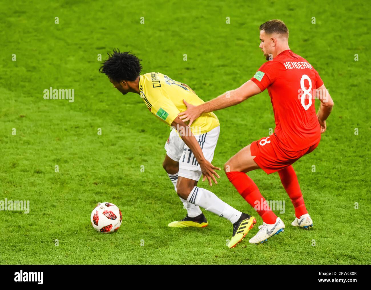 Moscow, Russia – July 3, 2018. England national football team midfielder Jordan Henderson against Colombia winger Juan Cuadrado during World Cup 2018 Stock Photo