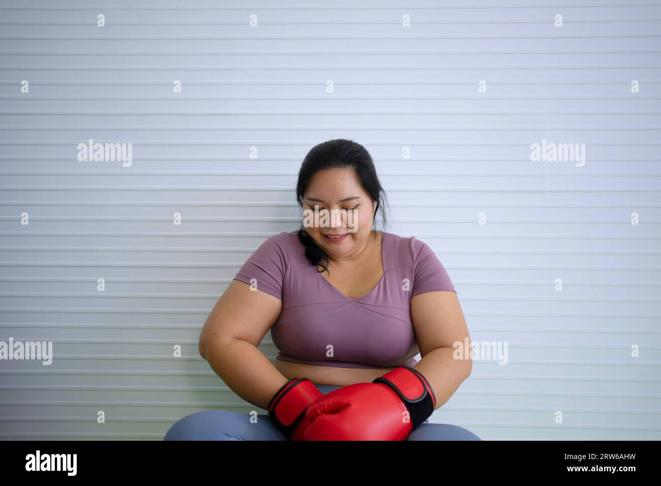 Plus Size Black Woman Sitting In Lotus Pose Meditating With Closed