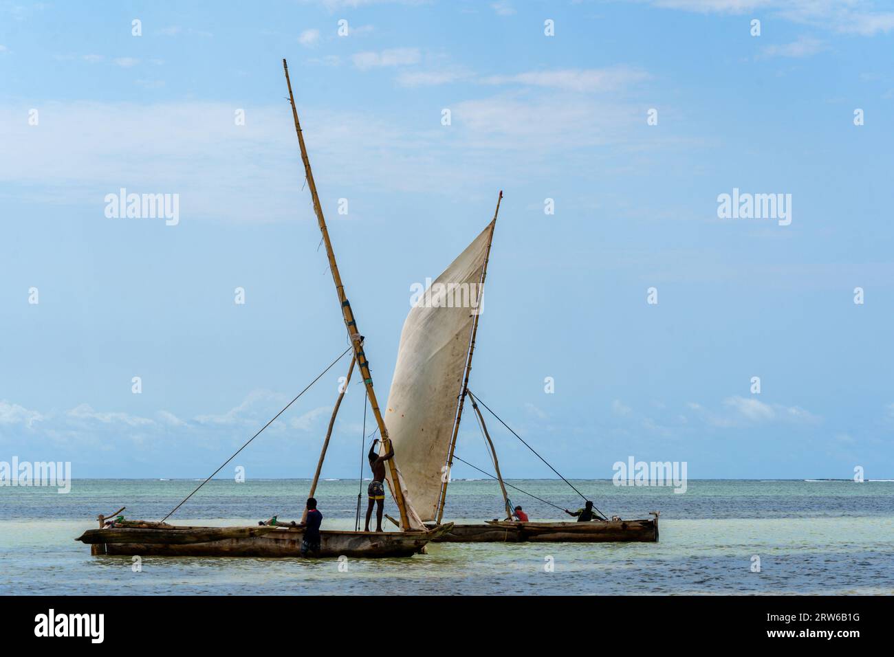 outrigger canoes as used to sail to fishing grounds with tall mast and