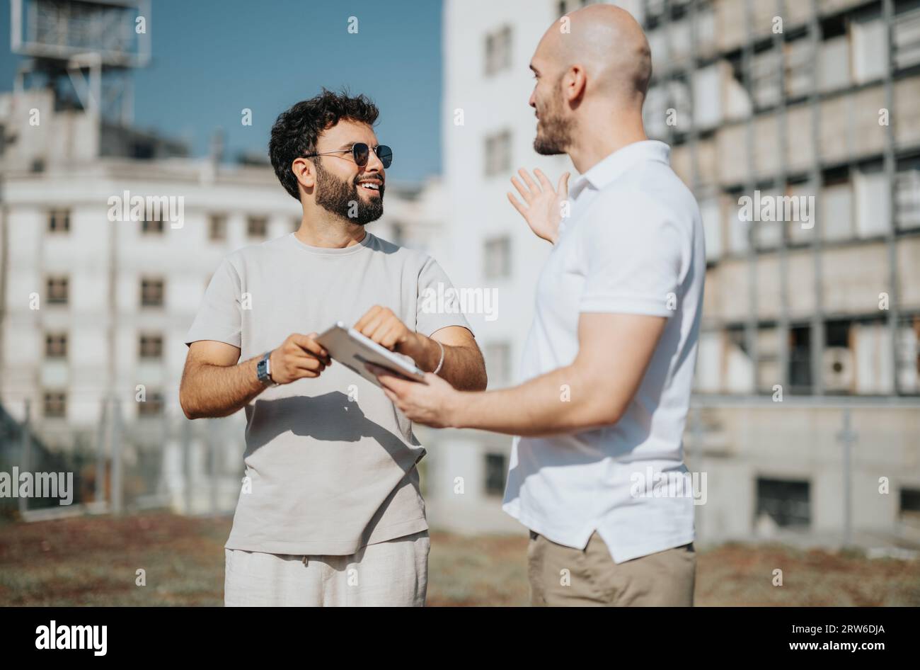 Architects Collaborating on Blueprint for Modern Building Design Stock Photo