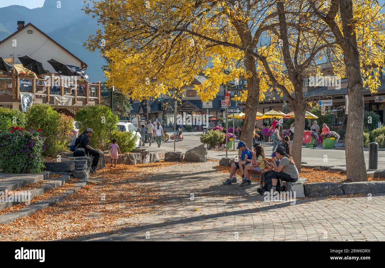 Canmore, Alberta, Canada – September 16, 2023:  people sit at a downtown plaza Stock Photo