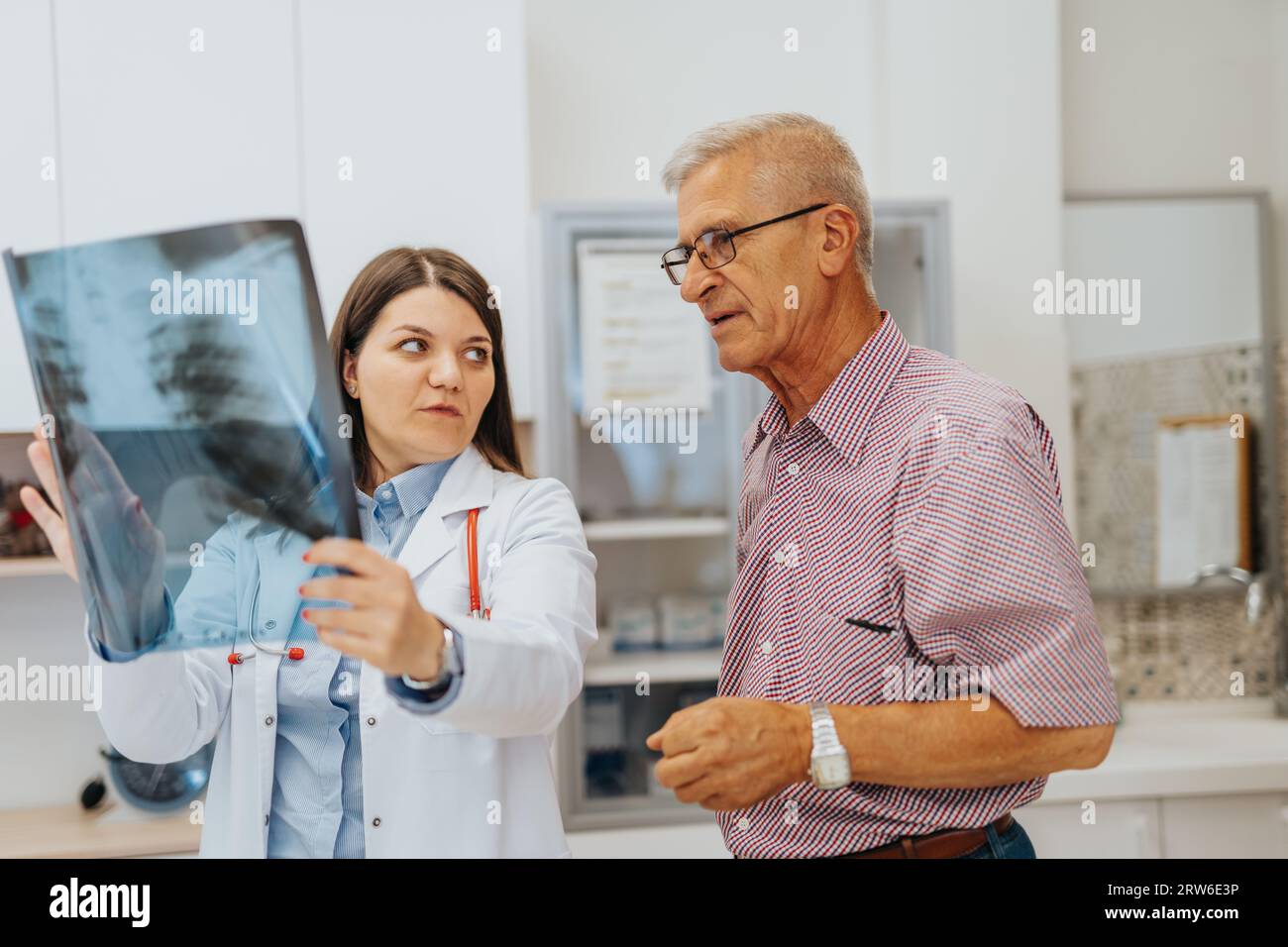 Doctor and Patient Reviewing X-Ray Results in Hospital Clinic Stock ...