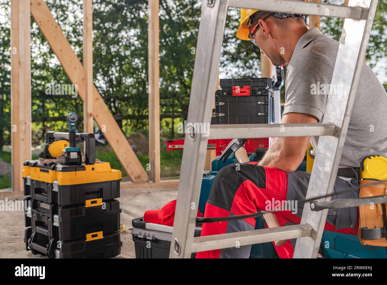 Construction Worker Taking Short Lunch Break. Construction Site and His Tools Boxes. Stock Photo