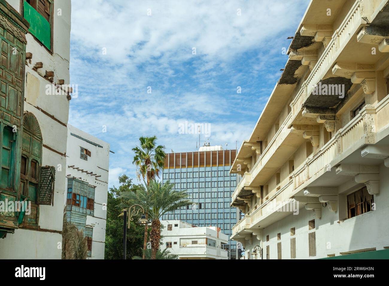 Al-Balad old town street with traditional muslim houses and modern building in the background, Jeddah, Saudi Arabia Stock Photo