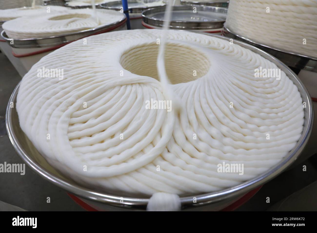 The cotton yarn on the production line is in a spinning factory Stock ...
