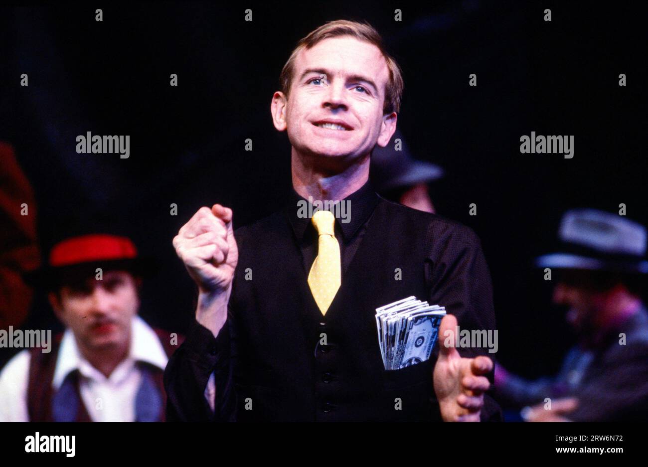 Ian Charleson (Sky Masterson) in GUYS AND DOLLS based on the story & characters by Damon Runyon at the Olivier Theatre, National Theatre, London SE1  09/03/1982  music & lyrics: Frank Loesser  book: Jo Swerling & Abe Burrows  set design: John Gunter  costumes: Sue Blane  lighting: David Hersey  choreography: David Toguri  director: Richard Eyre Stock Photo