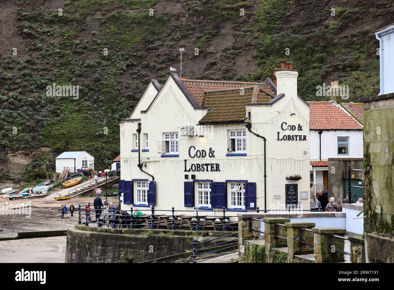 The Fishing Village of Staithes and the Cod and Lobster Pub Overlooking the Harbour North Yorkshire UK Stock Photo