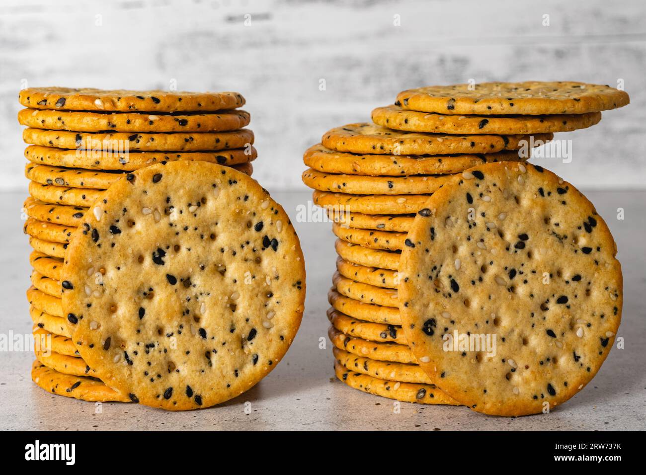 Sesame and poppy seed crackers close up on light grey background Stock