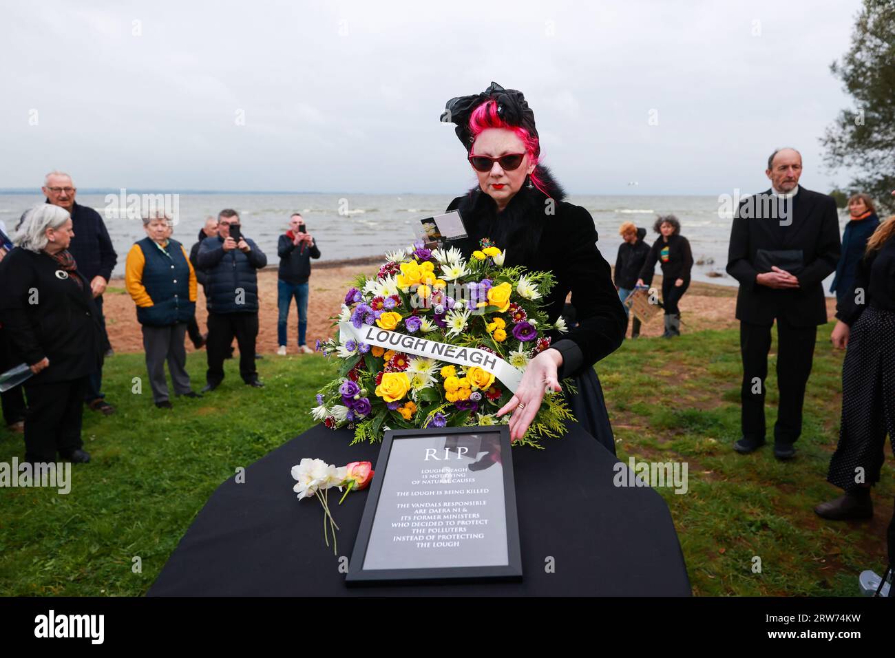 Sue Bamford places a wreath on a box symbolising a coffin as environmental campaigners hold a "wake" at Ballyronan beach for Lough Neagh lake amid claims toxic algae is killing the UK and Ireland's largest freshwater lake. Picture date: Sunday September 17, 2023. Stock Photo