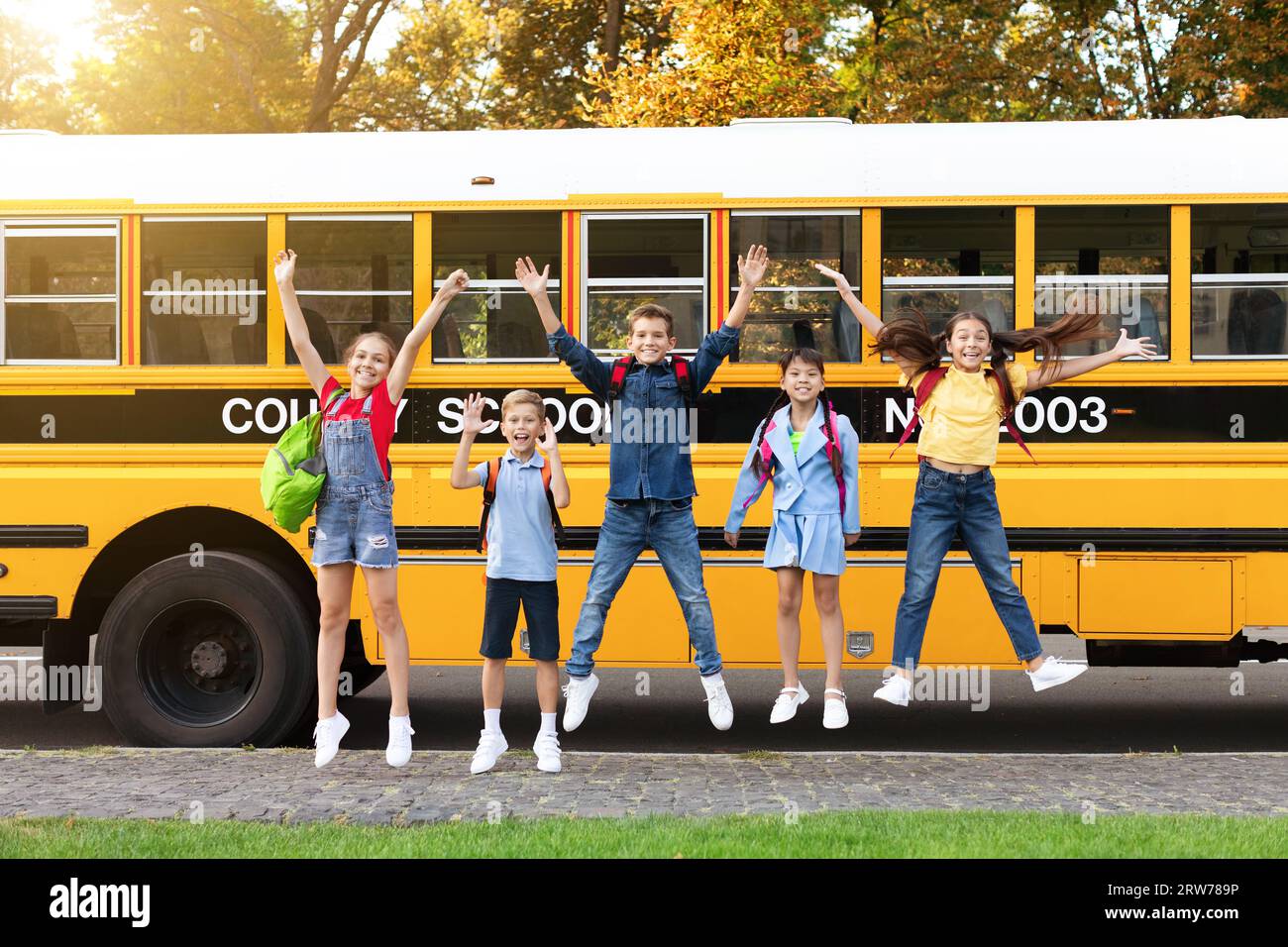 Group of five happy children jumping outdoors., Group of fi…