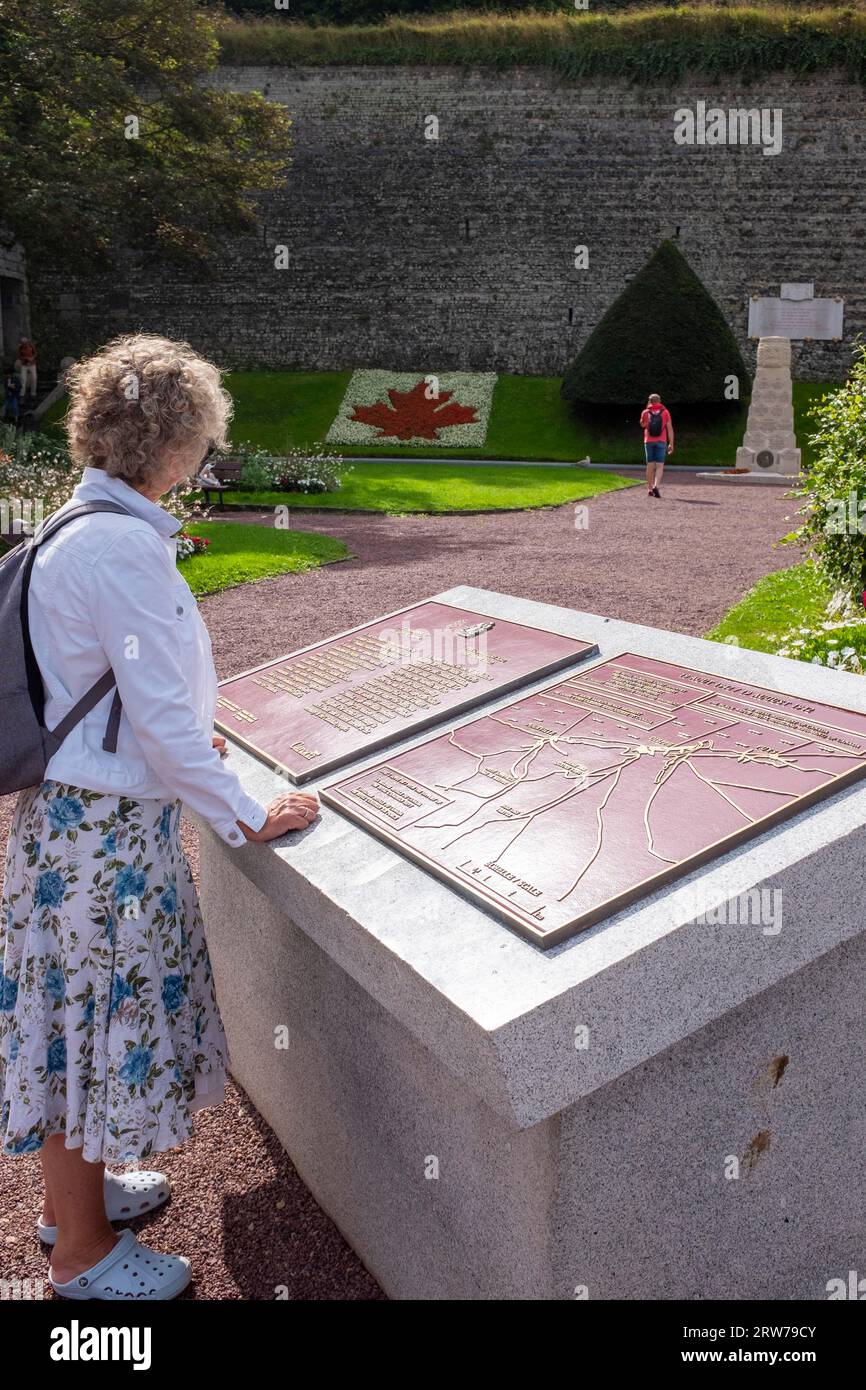 A visitor looks at the information at the memorial gardens to Canadian soldiers in Dieppe , Normandy Stock Photo
