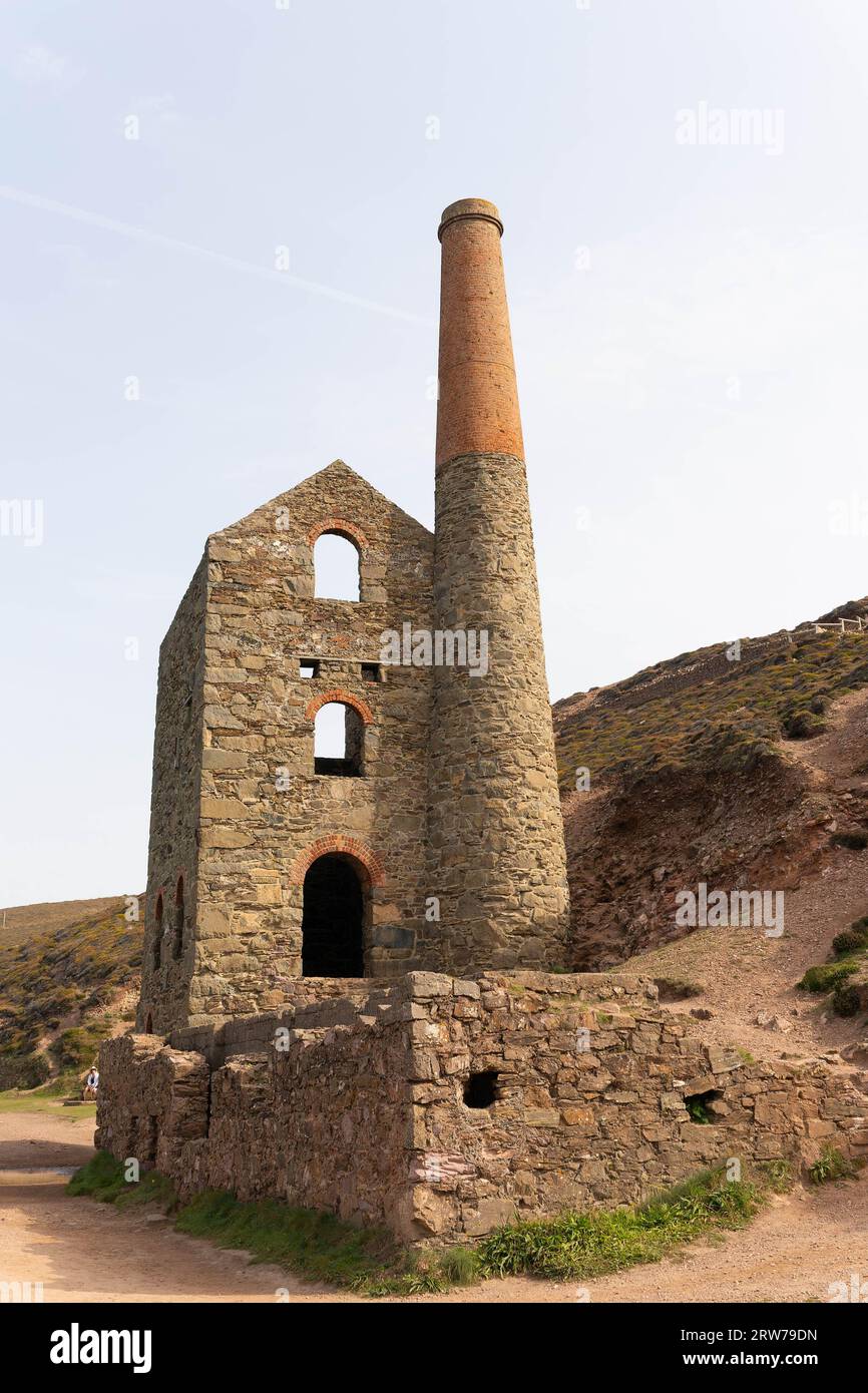 Historic Cornish tin mine engine house with tall brick chimney stack ...