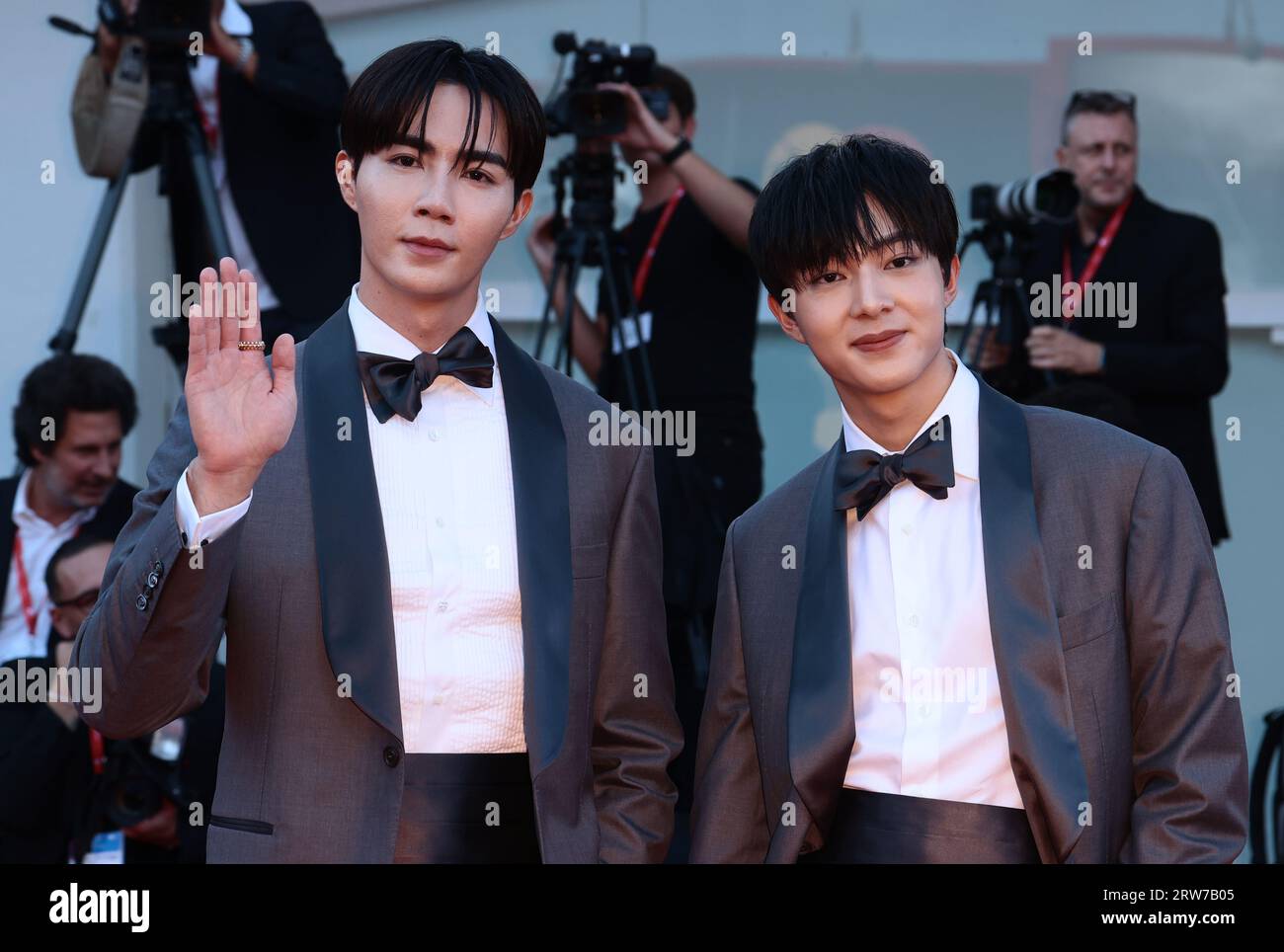 VENICE, ITALY - AUGUST 31:  Zee Pruk Panich and NuNew Chawarin attends a red carpet for the movie 'Ferrari' at the 80th Venice Film Festival Stock Photo