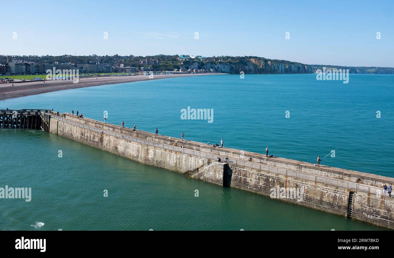 Fishing from the port harbour arm in Dieppe , Normandy  Dieppe is a fishing port on the Normandy coast of northern France    Credit Simon Dack Stock Photo