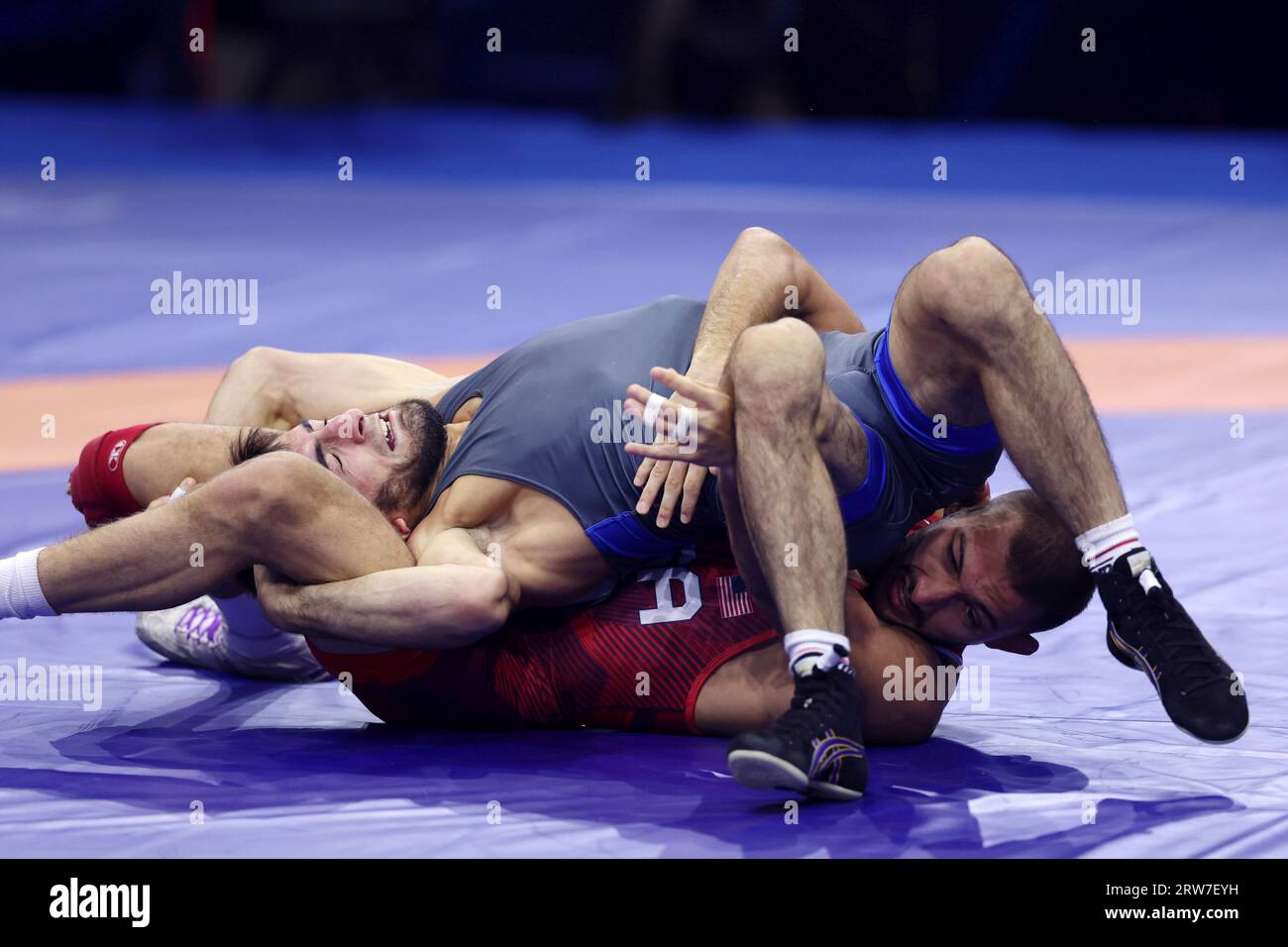 Vitali Arujau of United Stats (red) competes during the mens freestyle 61kg final match against Abasgadzhi Magomedov of Russia (blue) at the Wrestling World Championships in Belgrade, Serbia on September 17, 2023.