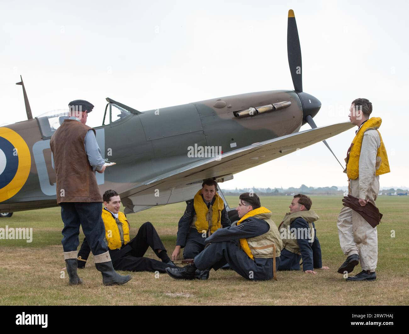 Re enactors pose with Supermarine Spitfire Ia N3200, Duxford Battle of Britain Air Show at IWM Duxford, Duxford, United Kingdom, 17th September 2023 (Photo by Cody Froggatt/News Images) Stock Photo