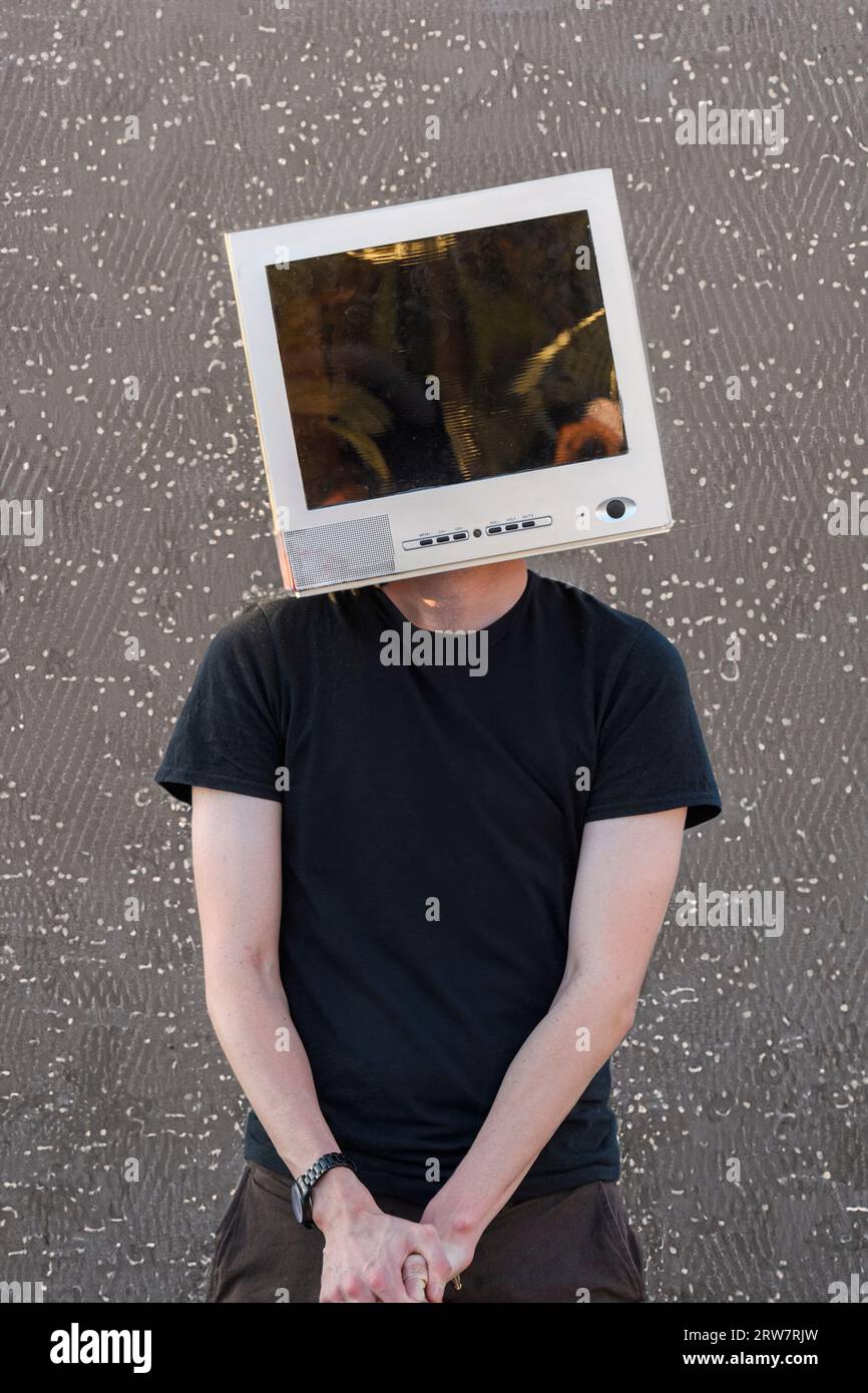 Youth with a CRT computer monitor on his head and a microchip in the