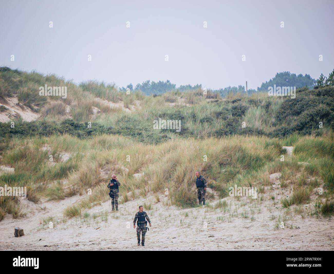 Neufchatel-Hardelot, France - Aug 18, 2023: French police officers and gendarmes conduct vigilant search and surveillance operations among the dunes, diligently working to apprehend illegal migrants attempting to reach the UK Stock Photo