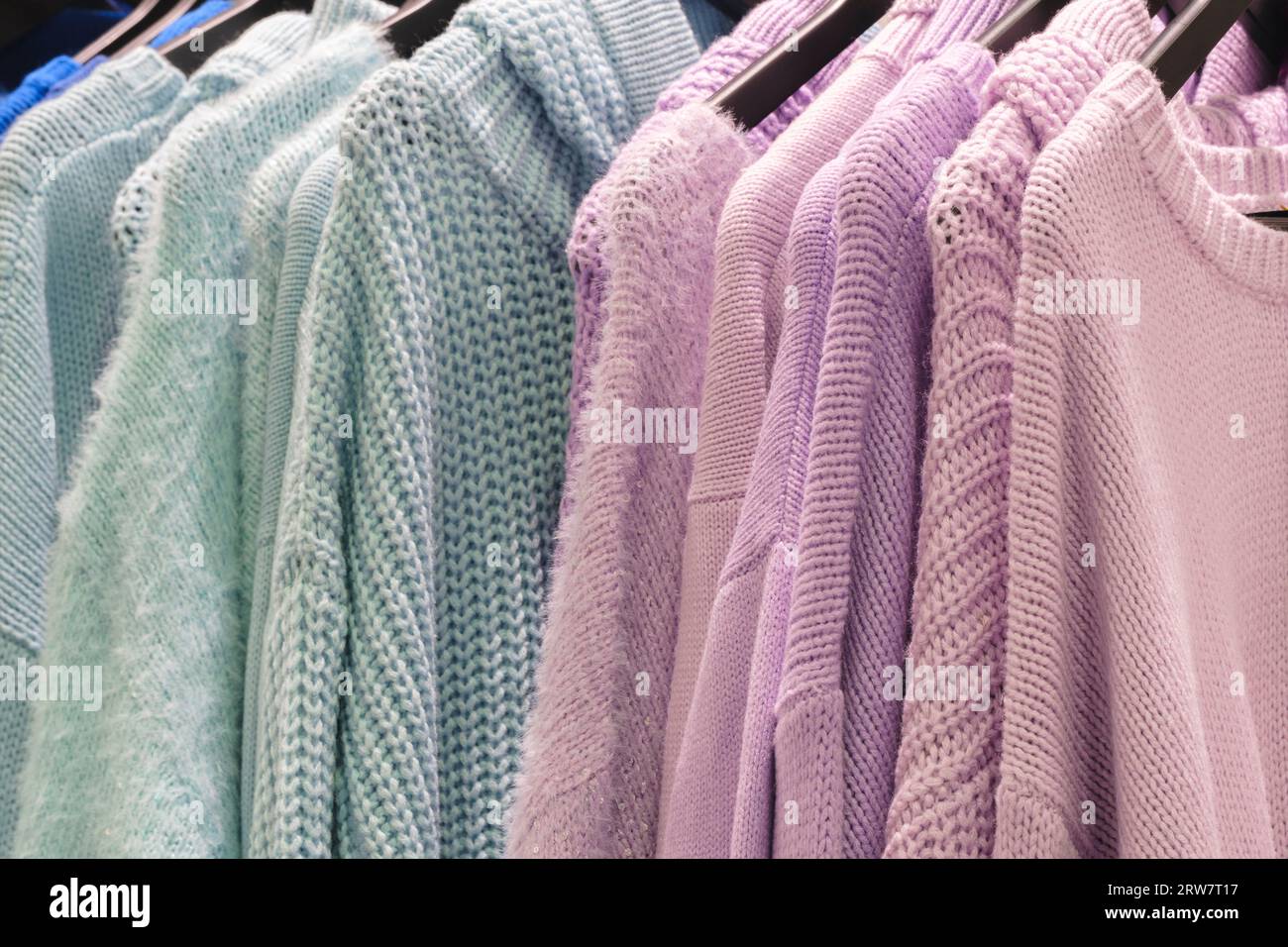 Fashion clothes on clothing rack Closeup of rainbow color choice female ...