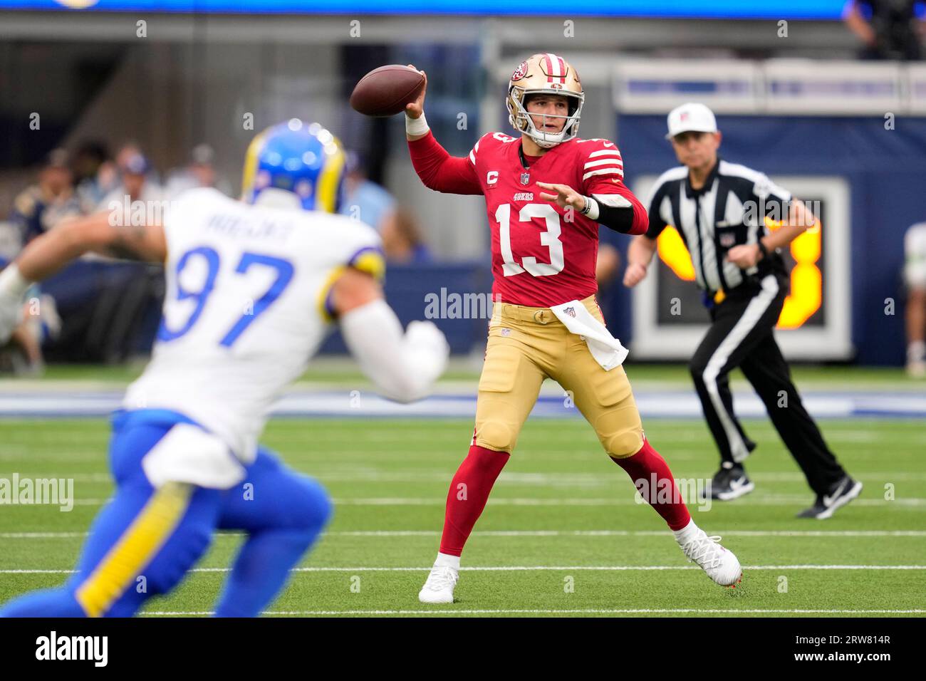 San Francisco 49ers quarterback Brock Purdy, right, passes as Los Angeles  Rams linebacker Michael Hoecht runs in during the first half of an NFL  football game Sunday, Sept. 17, 2023, in Inglewood,