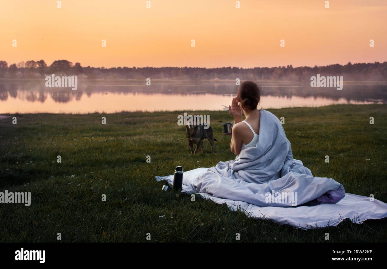 outdoor recreation by the lake with a dog. travel as a way of life. relaxation Stock Photo