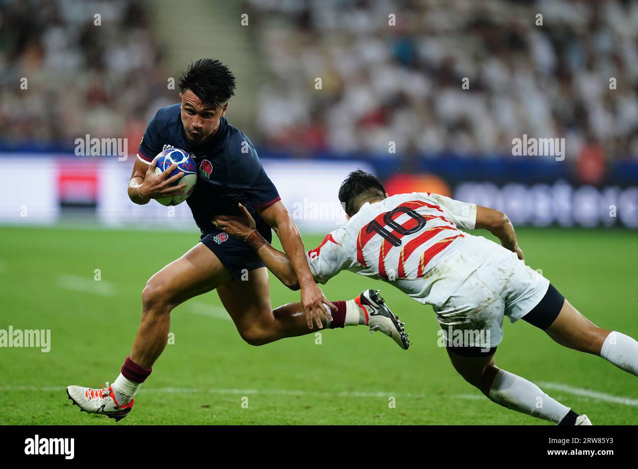 England's Marcus Smith (left) gets away from Japan's Rikiya Matsuda during the Rugby World Cup 2023, Pool D match at the Stade De Nice, France. Picture date: Sunday September 17, 2023. Stock Photo
