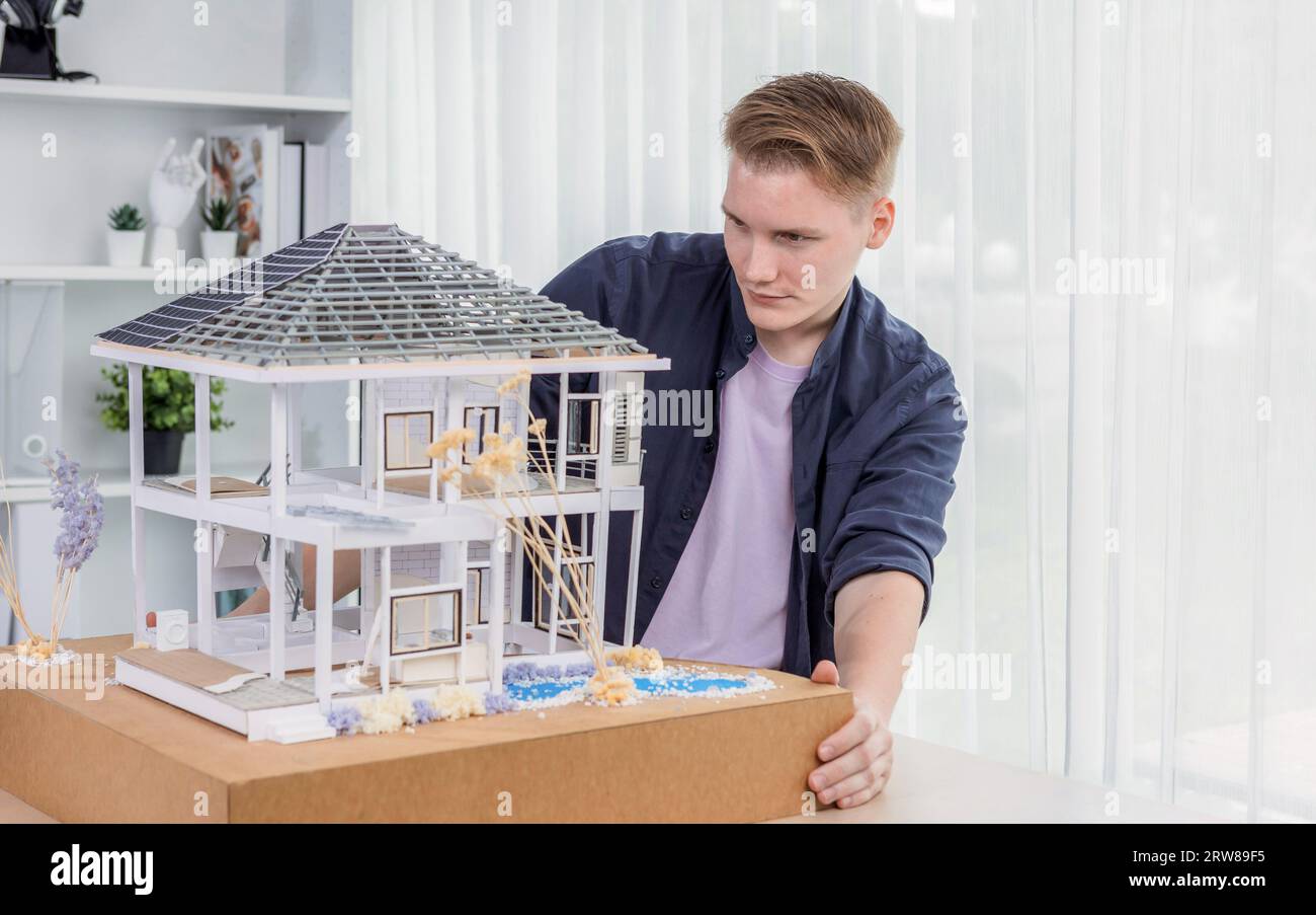Architect designer reviewing house frame model with no wall, brainstorming interior design and improvement idea with actual home scale. Professional Stock Photo