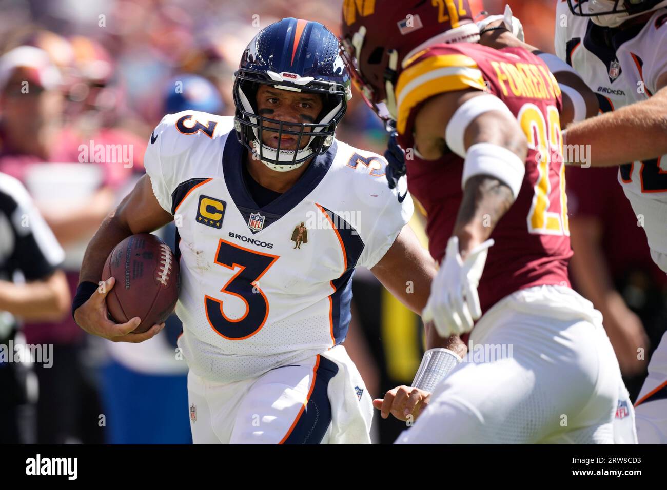Denver Broncos quarterback Russell Wilson (3) runs the ball against the Washington  Commanders in the first half of an NFL football game Sunday, Sept. 17,  2023, in Denver. (AP Photo/David Zalubowski Stock