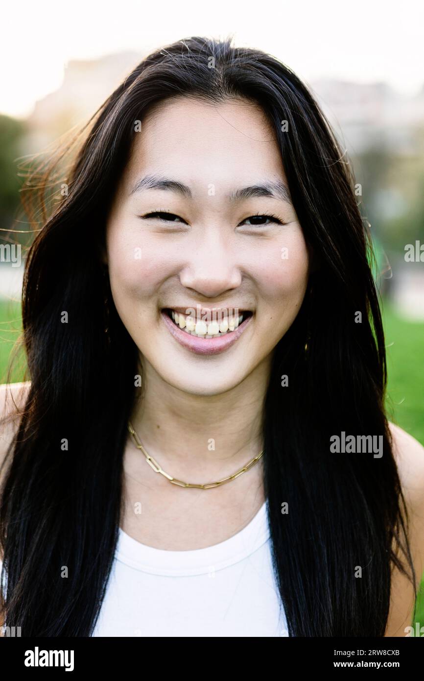 Vertical portrait of young asian woman smile outdoors Stock Photo - Alamy