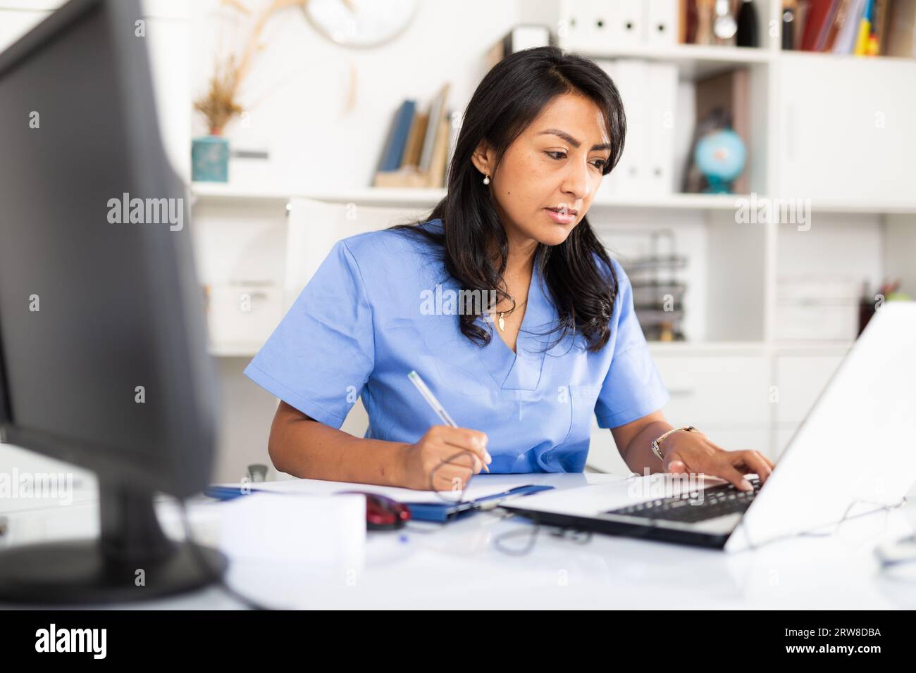 Portrait young nurse in scrubs hi-res stock photography and images - Alamy