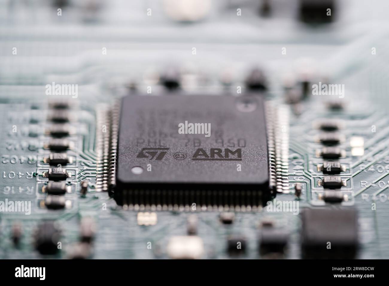 ARM company logo seen on microchip wich is soldered on a Printed Circuit Board (PCB).  Selective focus. London, United Kingdom, September 17, 2023 Stock Photo