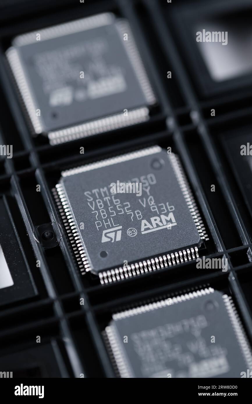 ARM company logo seen on STM32 microchip in the industrial chip carrier.  Concept. Selective focus. London, United Kingdom, September 17, 2023 Stock Photo