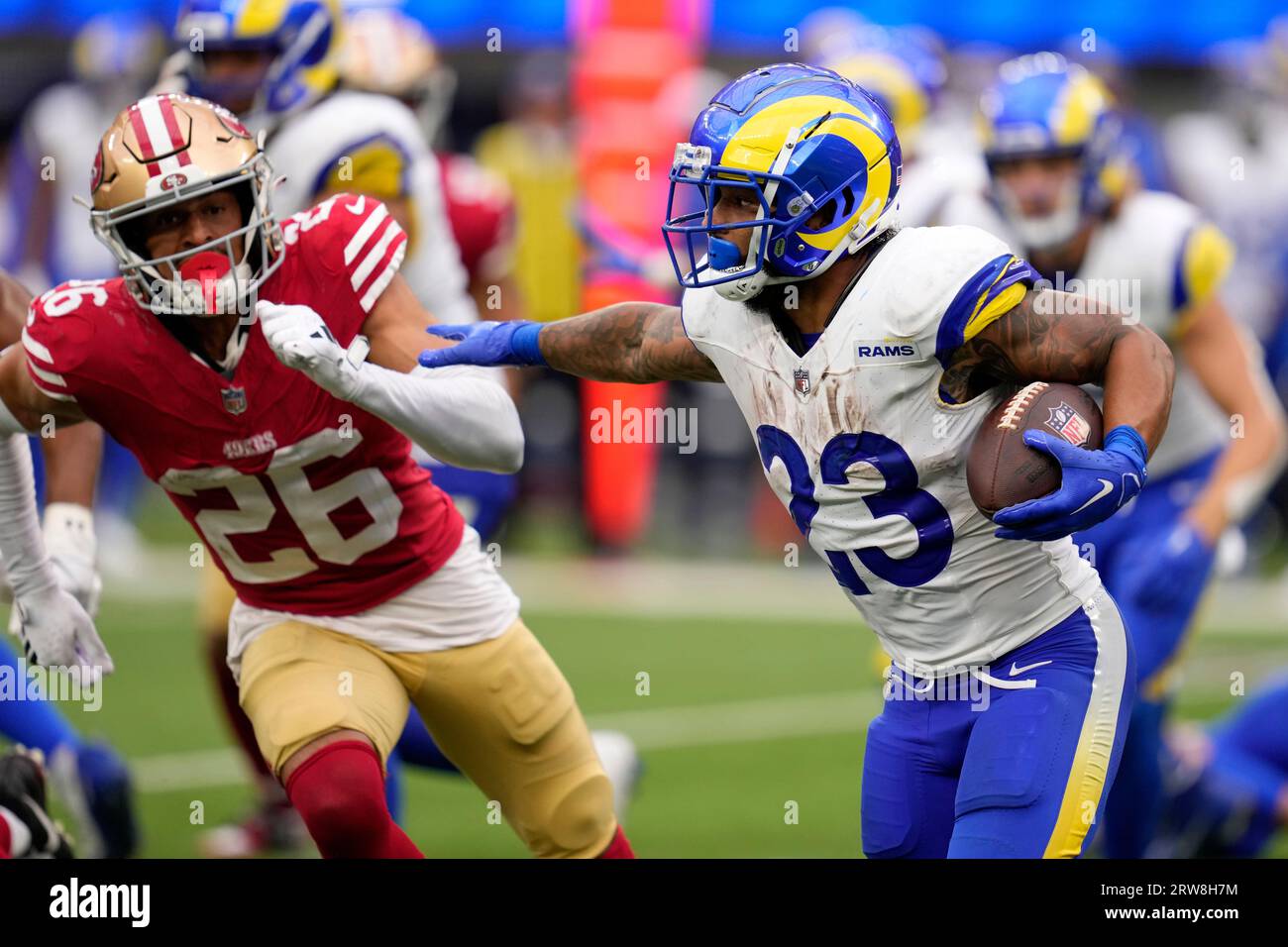 Los Angeles Rams Running Back Kyren Williams, Right, Fends Off San ...