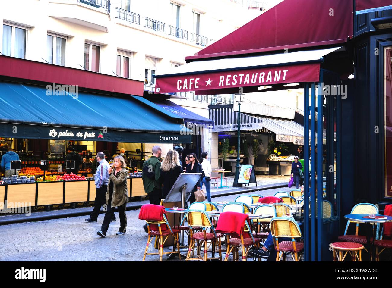 Cafes and fruit shops lining Rue in Paris France Stock