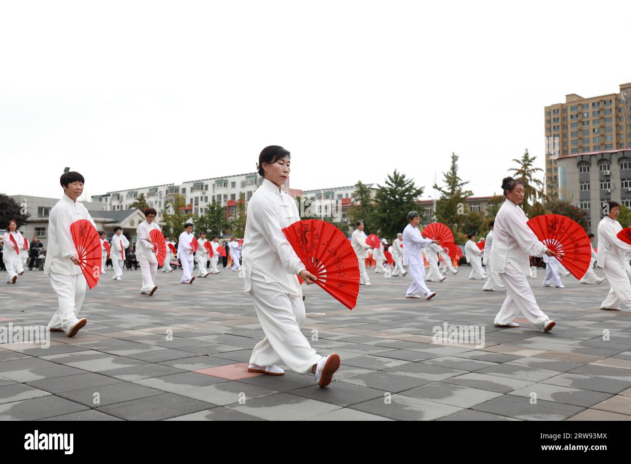LUANNAN COUNTY, China - October 10, 2021: people practice Tai Chi Kung Fu Fan in the park, North China Stock Photo