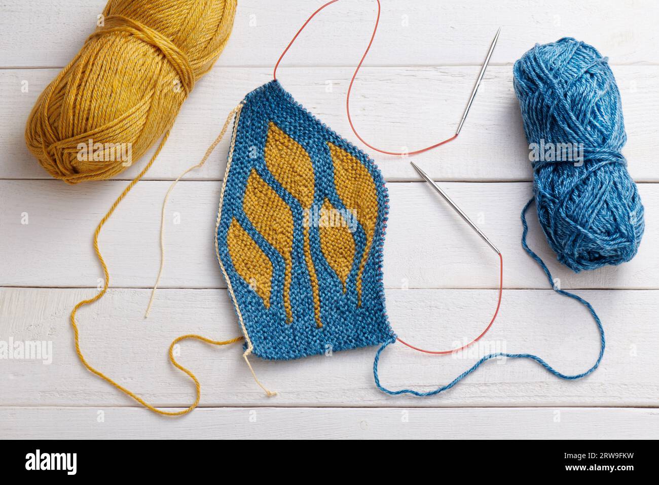 The process of knitting a hat with circular knitting needles using the short rows method Stock Photo