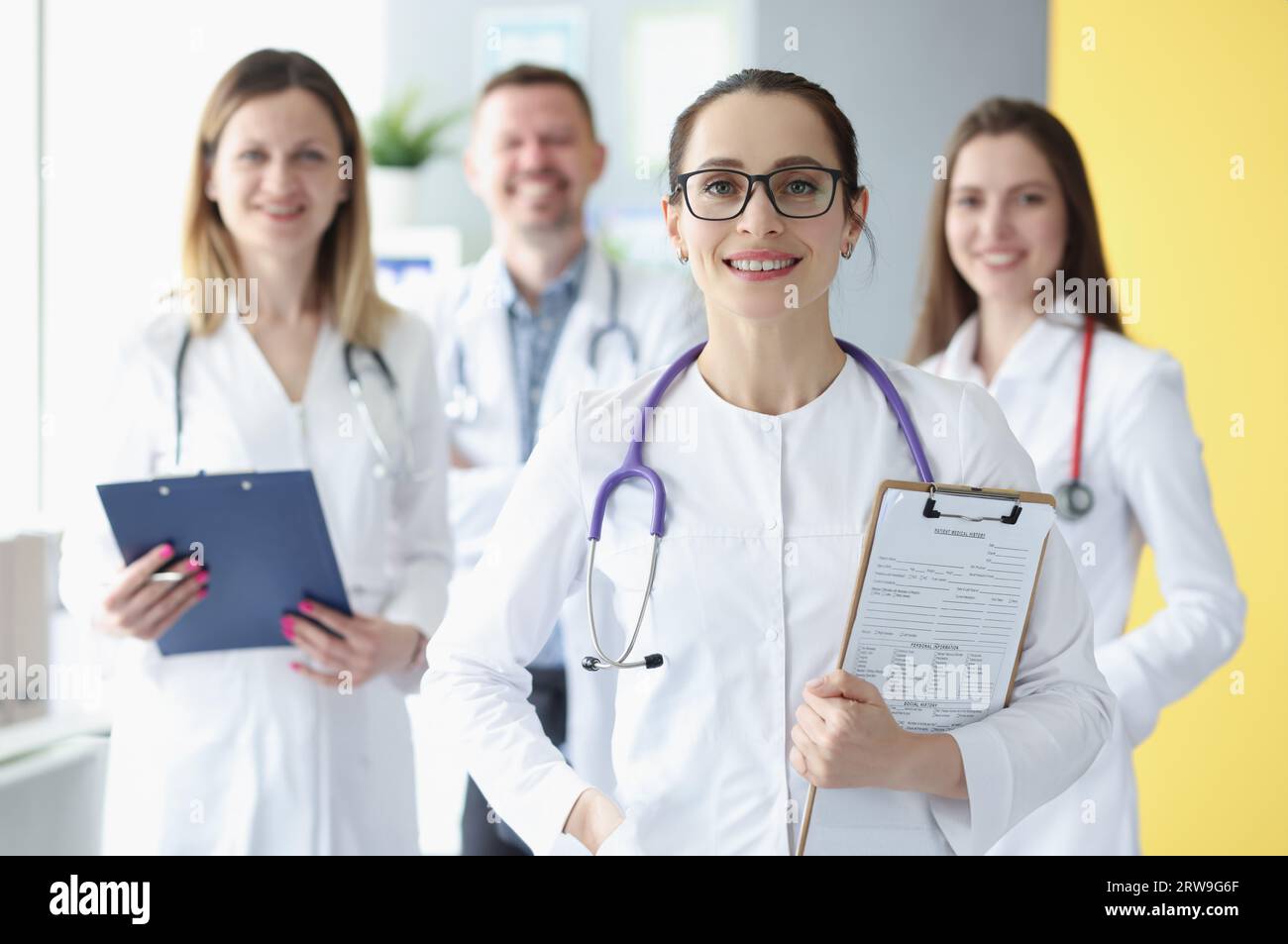 Portrait of medical team standing with clipboard in hospital Stock ...