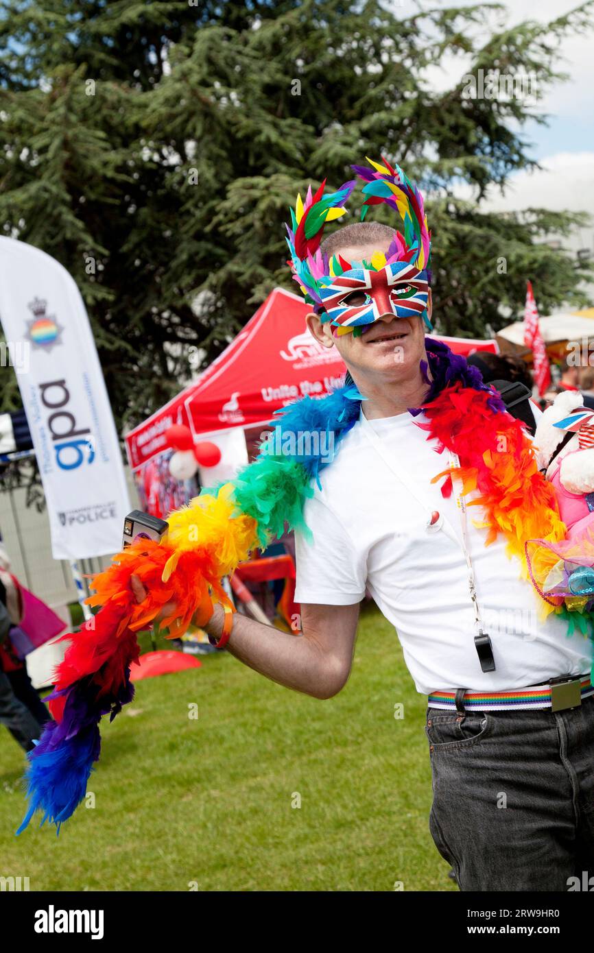 camp man posing for camera with feather bower and teddy at Oxford pride 2013 Stock Photo