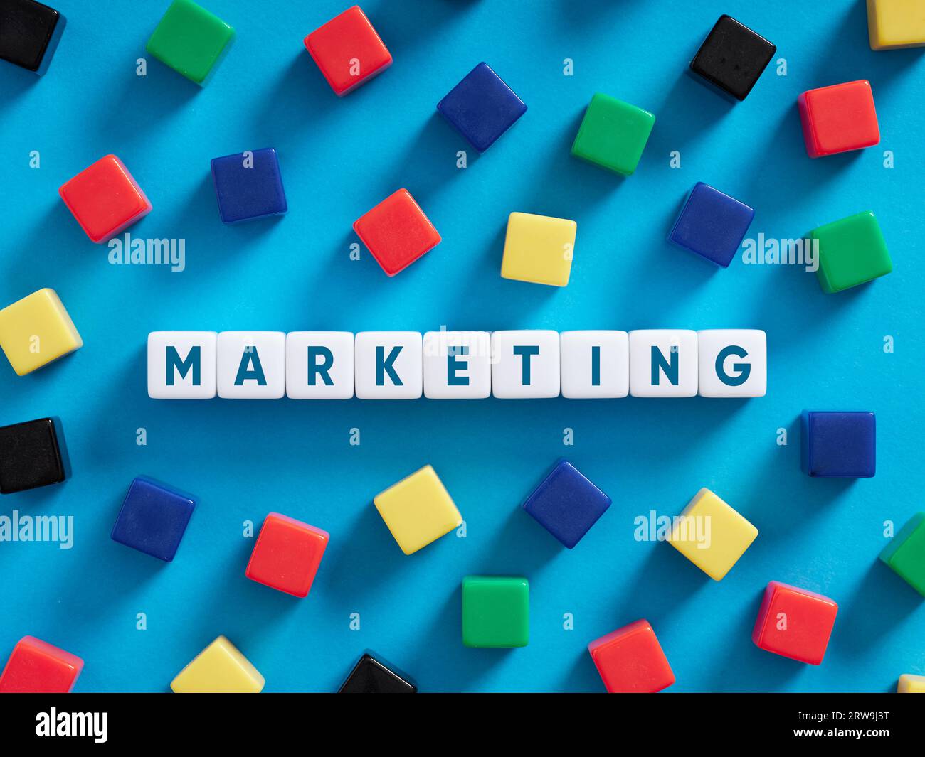 Business marketing concept. Colorful cubes on blue background with the word marketing. Stock Photo