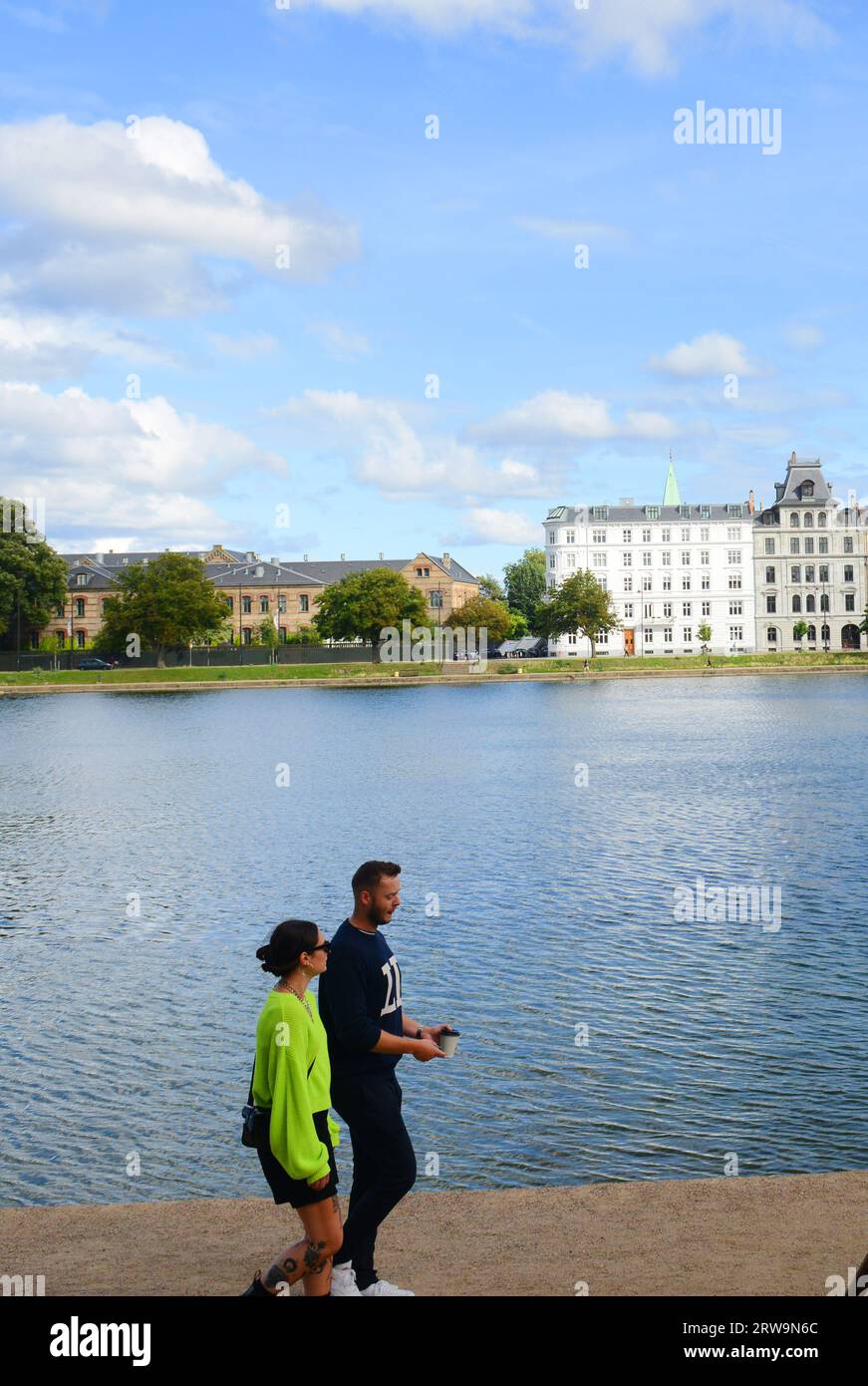 A couple walking along the Sortedam Lake in Copenhagen, Denmark. Stock Photo