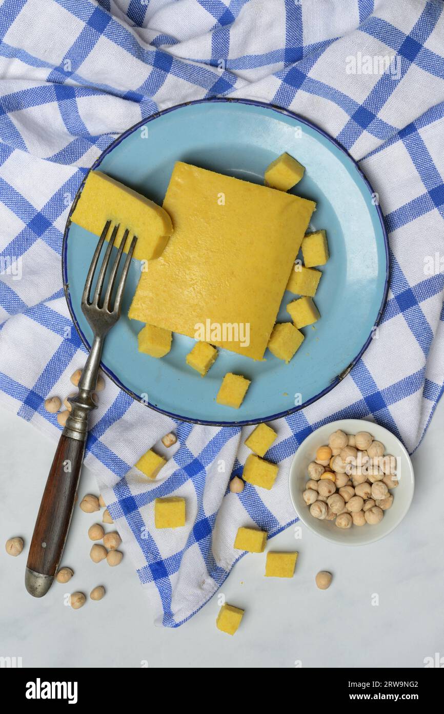 Kofu, chickpea tofu, block and cube on plate, chickpeas in small bowls