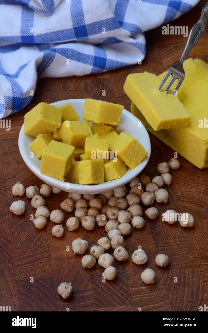 Kofu, chickpea tofu, block and cube in small bowls, chickpeas Stock